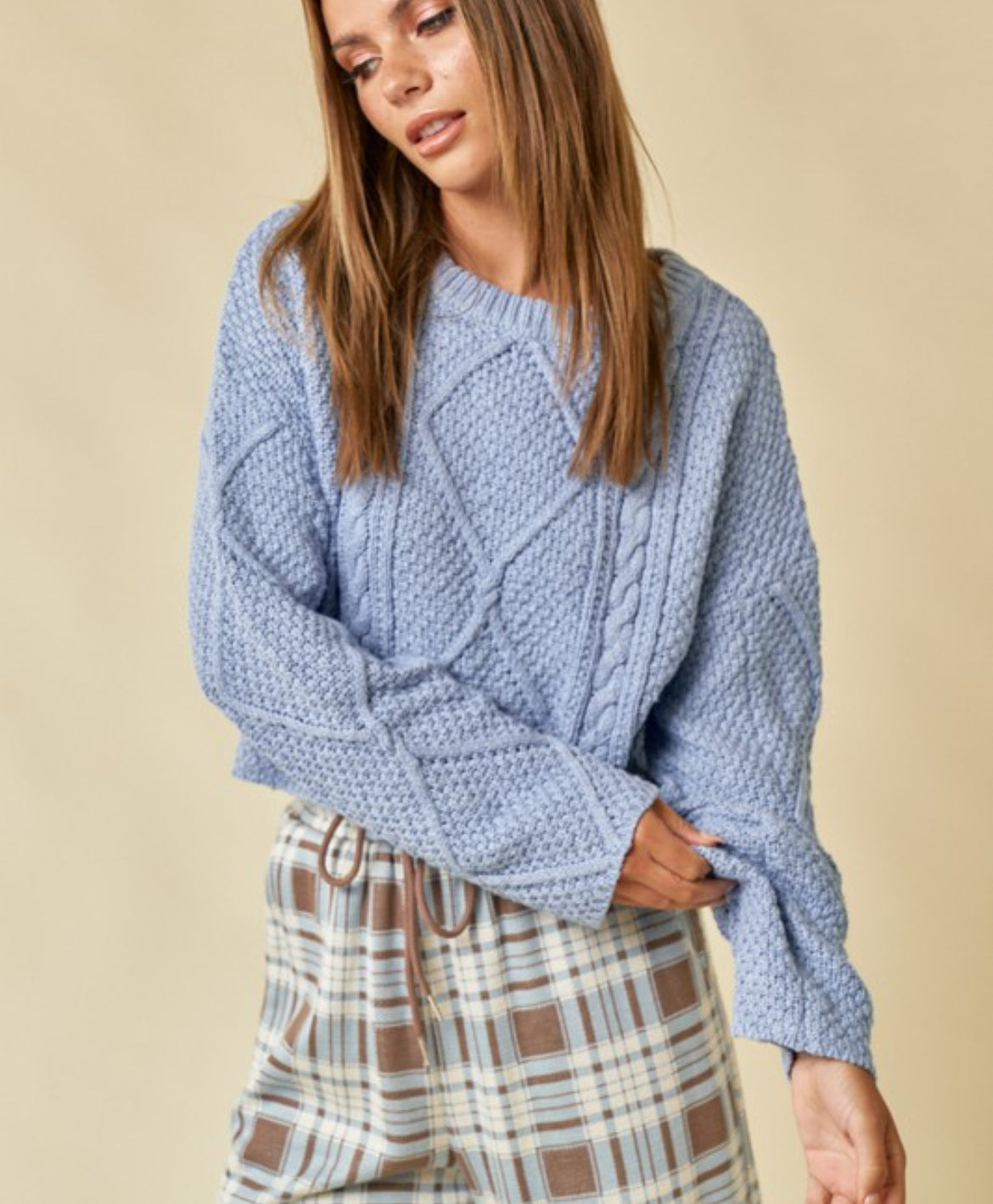 Blue cable knit cropped sweater.