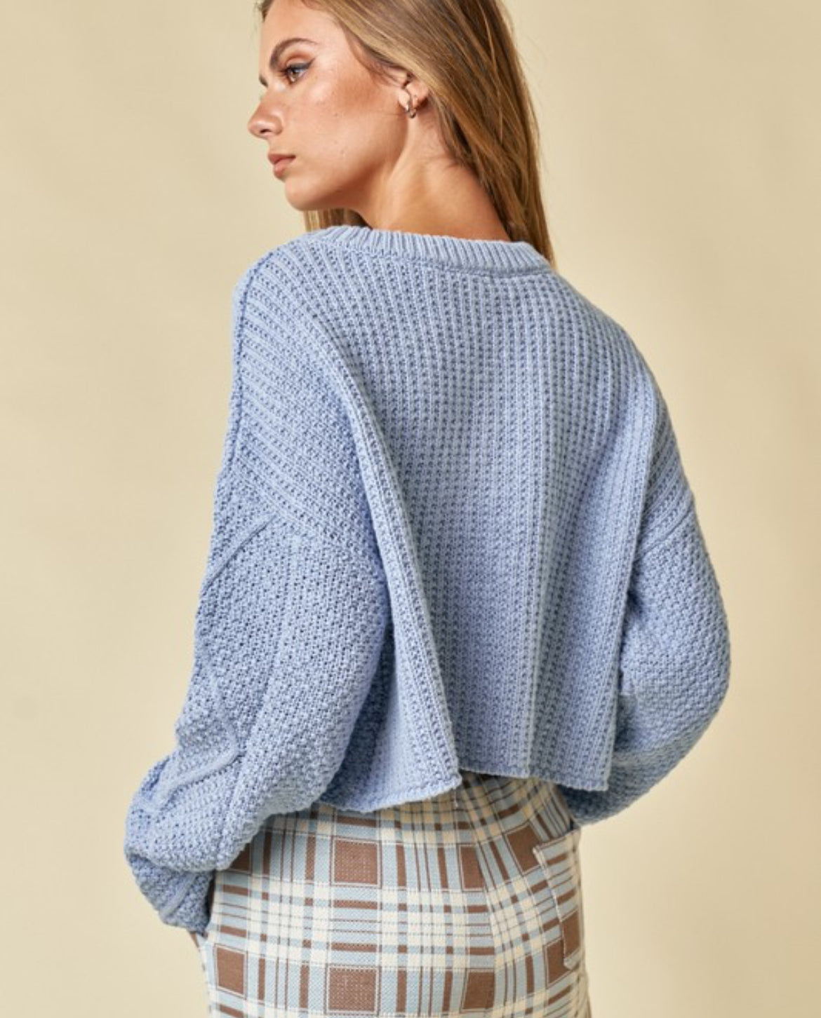 Blue cable knit cropped sweater.