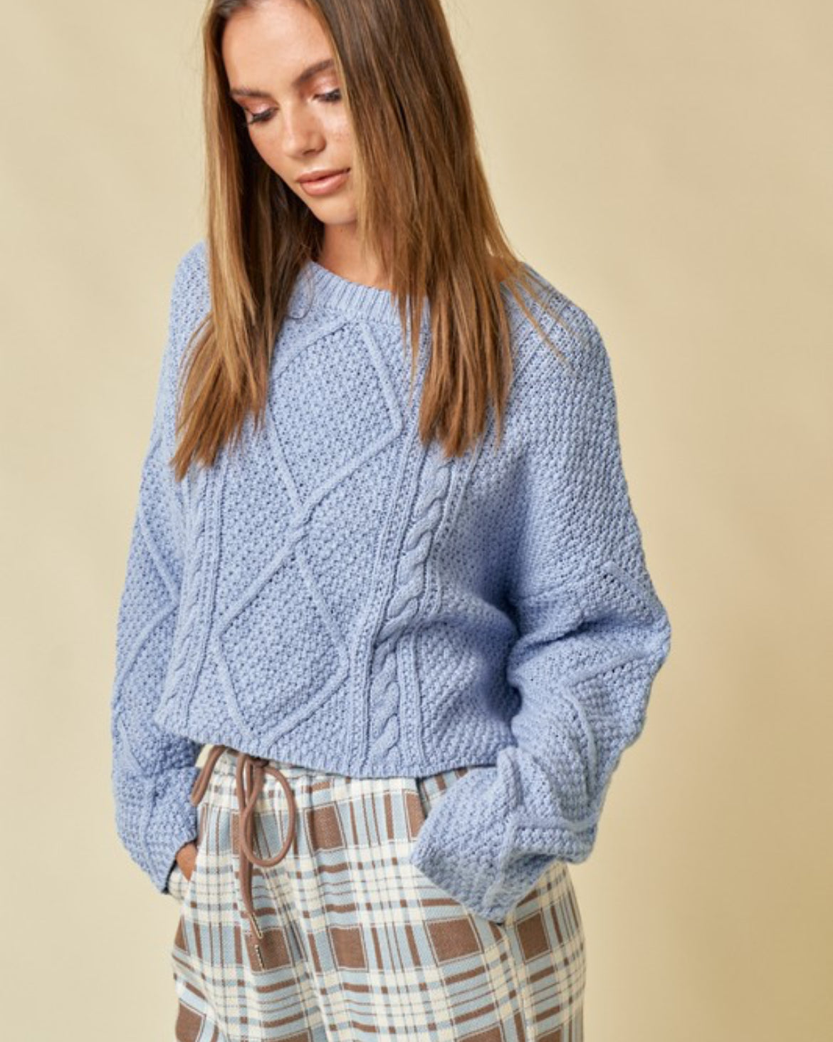 Blue cable knit cropped sweater.