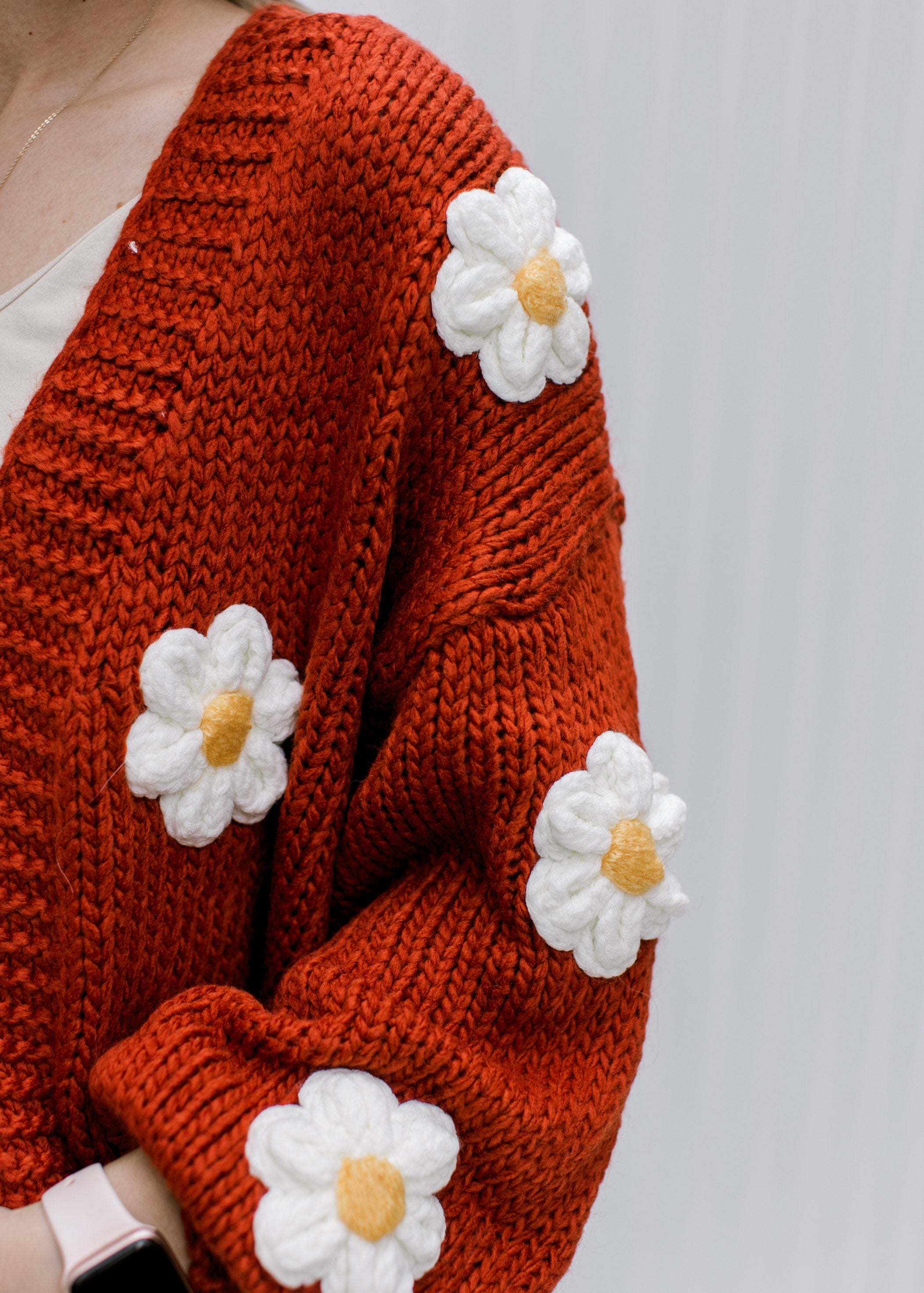 Rust Daisy Cardigan can be rewritten as Stylish Rust-Colored Daisy Patterned Cardigan for better Google SEO results.